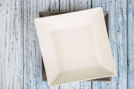 empty square plate on a wooden background