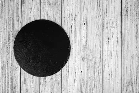 black slate stone on wooden backgroundの写真素材