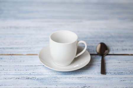white coffe cup on light wooden table