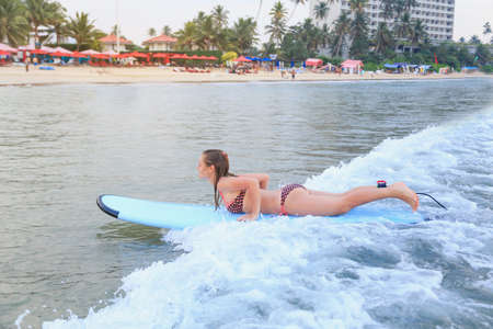 girl surfing on her belly in the ocean