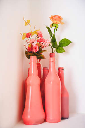 art decor white pink design, dried roses in colored bottles and jarsの写真素材