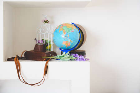 Travel concept design, globe and retro camera on white tableの写真素材