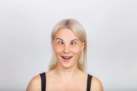 female face with funny expression, crazy girl's faceの写真素材