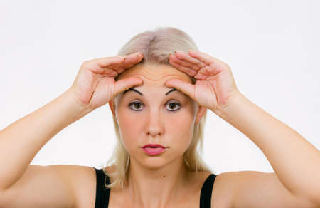 Face exercise brow raiser, woman lift her brows up with fingersの写真素材