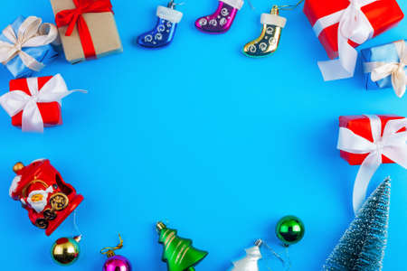 christmas or new year frame composition with copy space in centre on blue background. Flat lay, top view, copy spaceの写真素材