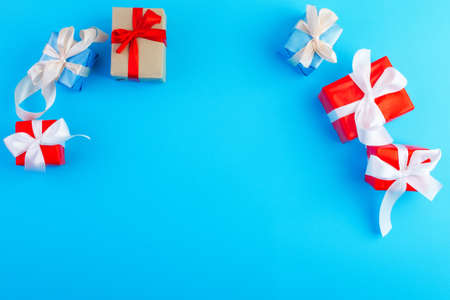 Holiday frame made of presents on blue background. Flat lay, top view, copy spaceの写真素材