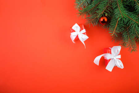 Christmas red background with fir tree and decor. Top view with copy space