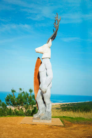 monument to surfing, reindeer holding surfboard. Nazare, Portugalの写真素材
