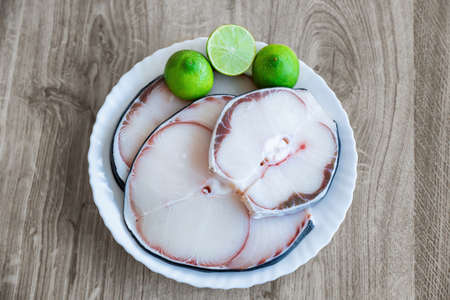 raw blue shark meat and lime on white plateの写真素材