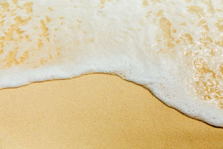 Ocean surf, edge of sea foam and sand, holidays vacation conceptの写真素材