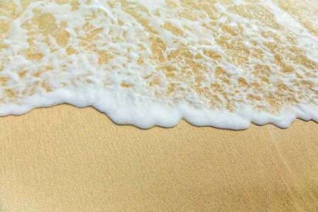 Ocean surf, edge of sea foam and sand, holidays vacation conceptの写真素材