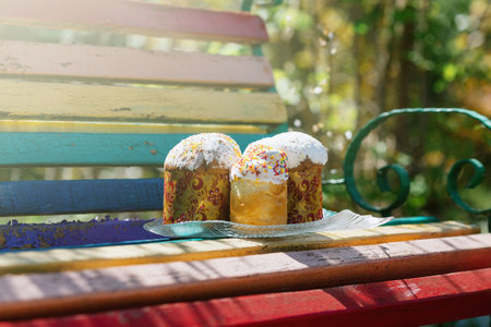 Three easter cakes in the nature against a background of a green spring grassの写真素材
