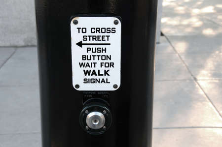 waiting at the crosswalk to cross the streetの写真素材