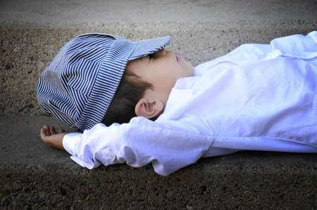 a small boy a sleep on a stairwell