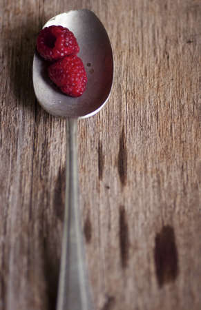 Two raspberries in old spoonの写真素材
