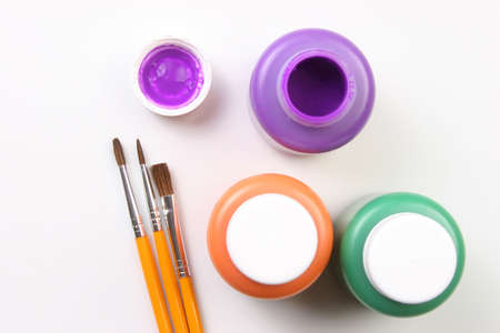 Water based paints and brush on a white background.の写真素材