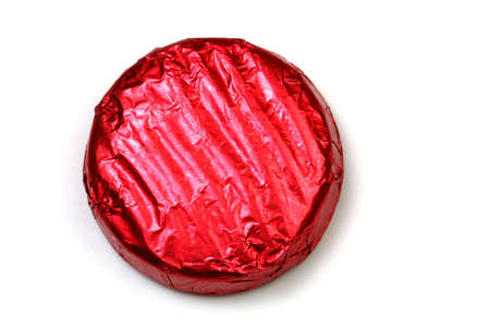 Round wrapped chocolate with stripes on a white background.の写真素材