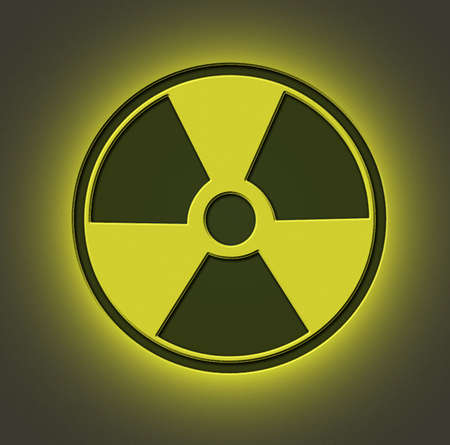 Radioactive sign engraved on metal sheet with yellow lightの写真素材