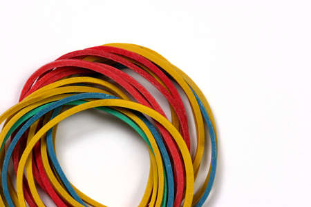 Colored rubber bands over a white background.の写真素材