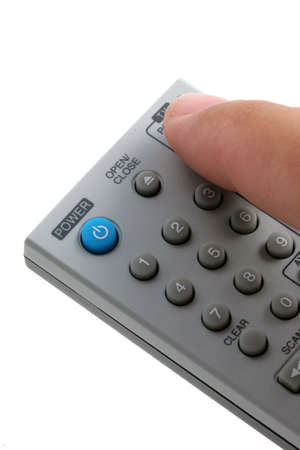Remote control with finger changing channels, vertical presentation.の写真素材