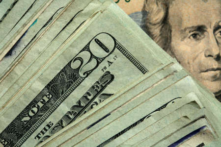 Twenty dollar bills stacked in diagonal array showing Jackson's face in the background.の写真素材