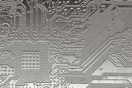 Computer PCB board with details of connections and electronic designs with a metallic appeareance for background use.の写真素材