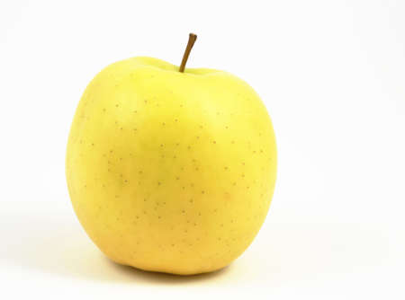 Yellow apple on a white background, lateral view, horizontal format.の写真素材