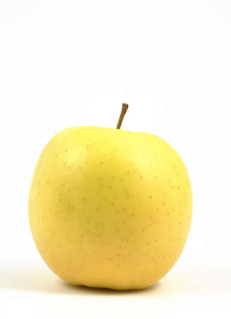 Vertical view of a yellow apple on a white background.の写真素材