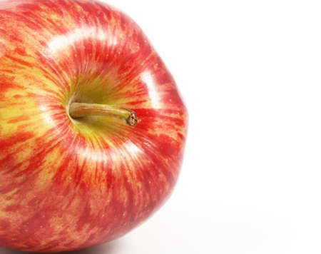 Lateral appearing red apple over a white background.の写真素材