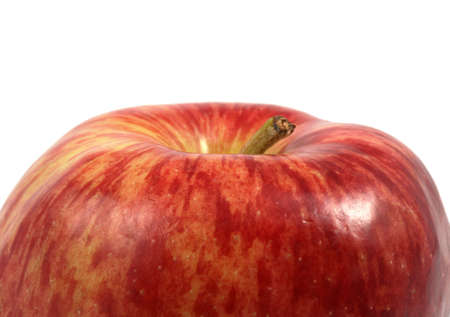 Cropped view of the top of a red apple over white background.の写真素材