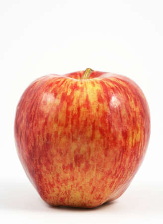 Vertical view of a red apple over a white background.の写真素材