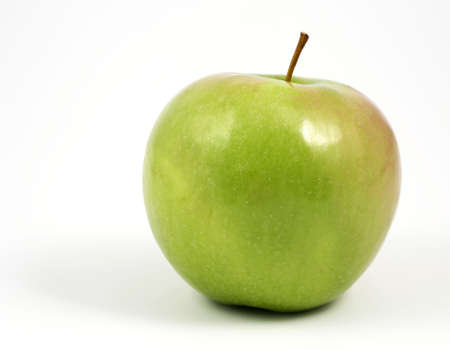 Horizontal format showing a green apple over a white background.の写真素材