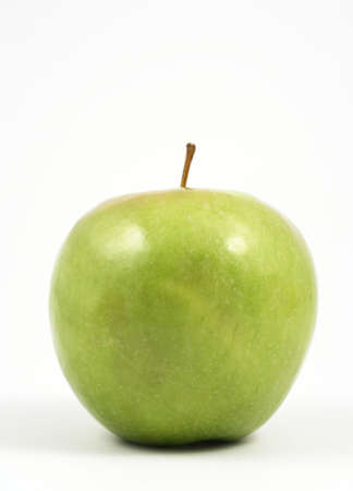 Vertical photo of a green apple over a white background.の写真素材
