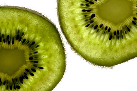 Thin sliced kiwi fruit in a backlit setting for a high key exposure in macro view.の写真素材