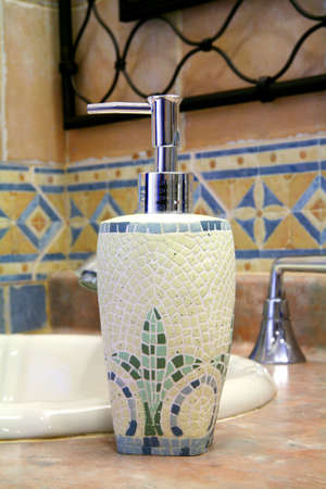 Trendy soap dispenser along a sink in a bathroom.の写真素材
