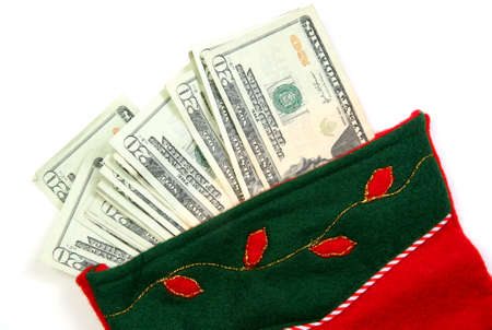 Christmas sock with season's details and money in it illustrating the concept of money spending.の写真素材