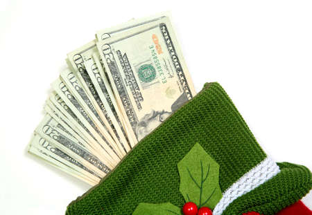 Christmas sock with season's details and money in it illustrating the concept of money spending.の写真素材