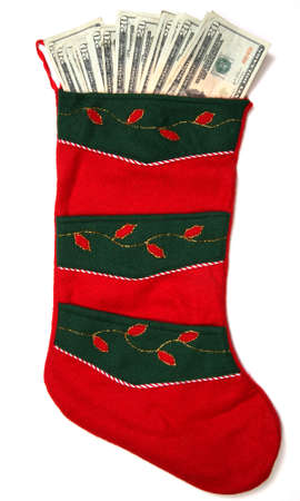 Christmas sock with season's details and money in it illustrating the concept of money spending.の写真素材