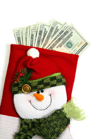 Christmas sock with season's details and money in it illustrating the concept of money spending.の写真素材