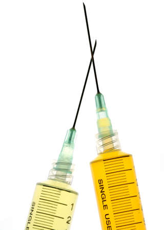 Back lighted image of a syringe containint colorful liquids for a high key effect.