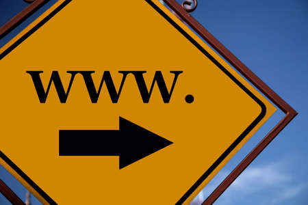 WWW symbol on a yellow romboid road sign with an ornamental frame of bronze color.の写真素材