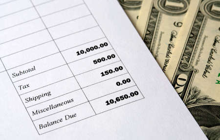Detail of a bill with money to be paid showing taxes shipping and total.の写真素材