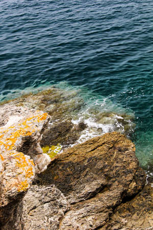 rocks with moss yellow, by the seaの写真素材