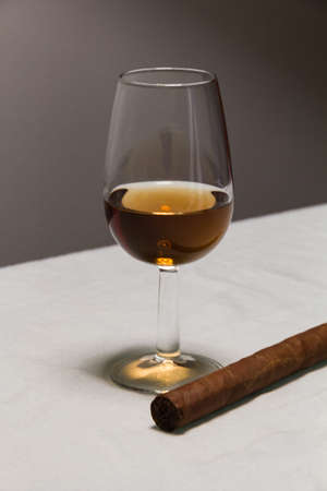 Photo of a glass of Rum with a cigarの写真素材
