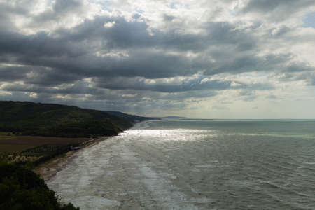 View of the coast with bad weather and the rays of light through the cloudsの写真素材