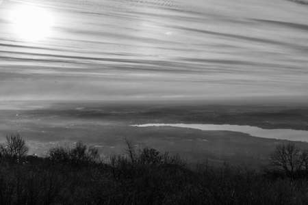Panoramic photo, in black and white, on Lake Varese, taken from Campo dei Fiori, with a cloudy skyの写真素材