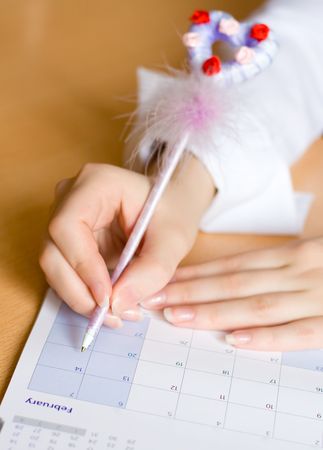 Woman's hands with calendar and penの写真素材