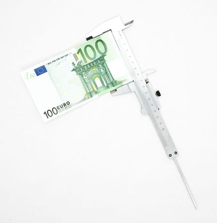 Measuring euro with caliperの写真素材