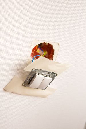 Picture of a white switcher torn out of  the wall
