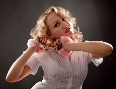 Young blond woman in handcuffsの写真素材